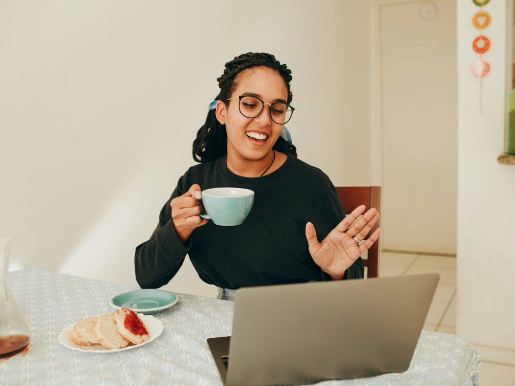 Woman holding a coffee mug during a friendly video call