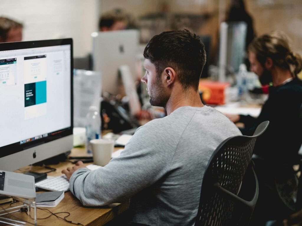 Designer reviewing a website layout on a large monitor